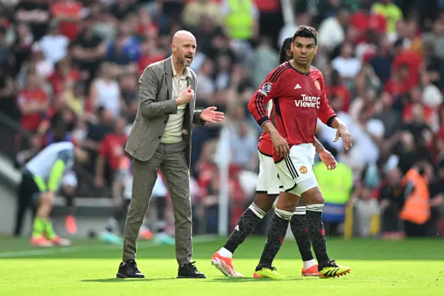 Erik ten Hag, Manager of Manchester United, speaks with Casemiro