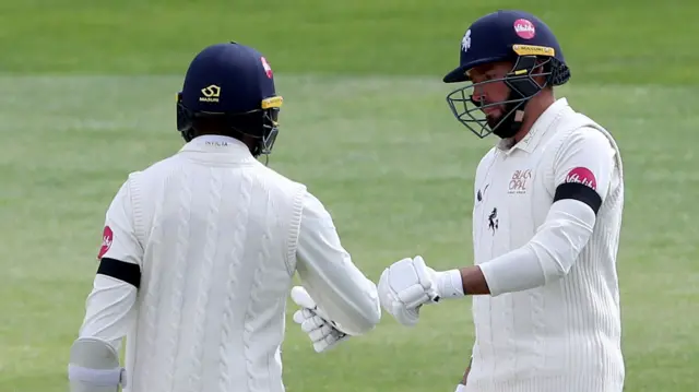 Jack Leaning and Daniel Bell-Drummond bump gloves