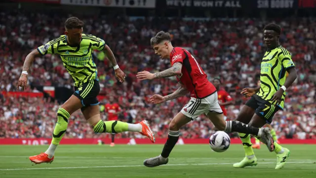 Alejandro Garnacho of Manchester United in action with Ben White and Bukayo Sakaof Arsenal during the Premier League match between Manchester United and Arsenal FC