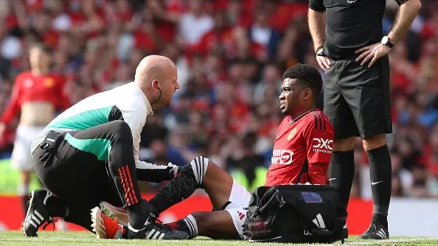 Amad of Manchester United lies injured