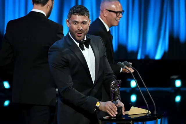 Presenter Rav Wilding accepts the daytime award for BBC One's Scam Interceptors