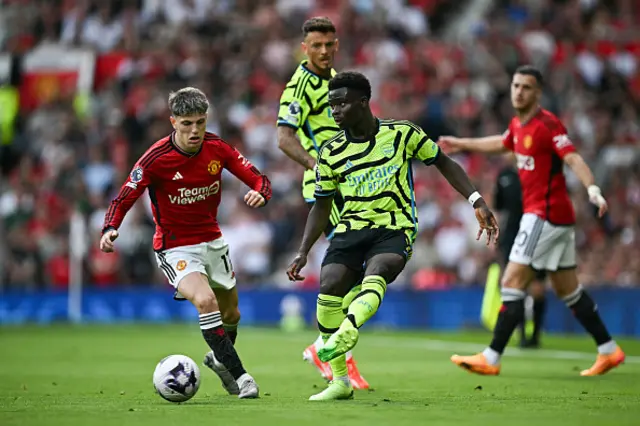 Alejandro Garnacho vies for the ball with Arsenal's Bukayo Saka