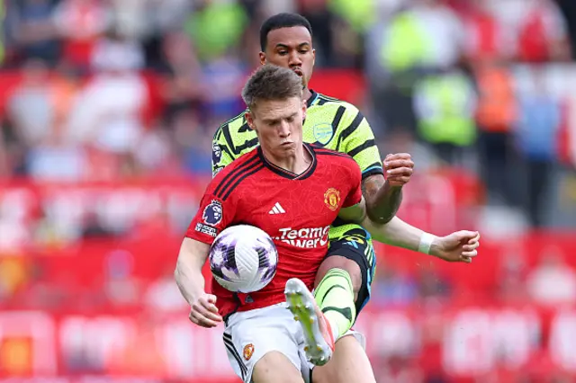 Gabriel Magalhaes of Arsenal tackles Scott McTominay of Manchester United