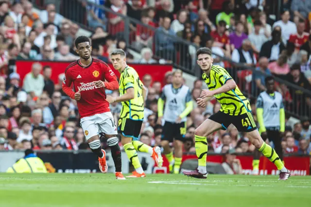 Amad of Manchester United in action with Declan Rice