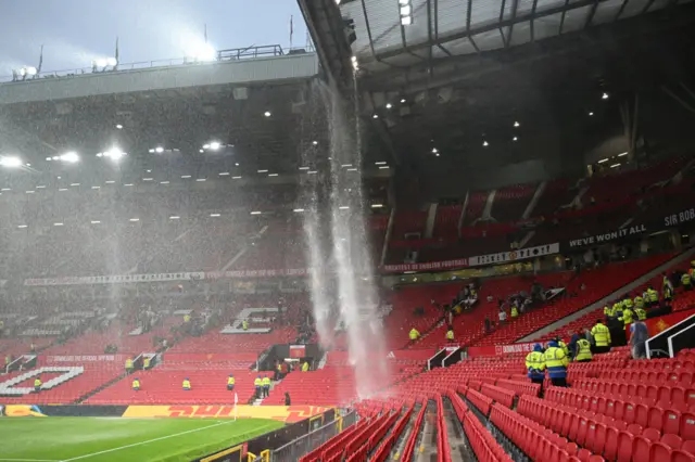 A general view as the drainage pipe in the roofs of the Sir Alex Ferguson Stand and East Stand leaks and pours onto the seats below following heavy rainfall after the Premier League match between Manchester United and Arsenal FC