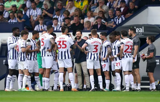 West Brom players have a drink during a break in play