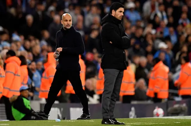 Pep Guardiola (L) and Arsenal's Spanish manager Mikel Arteta watches the players