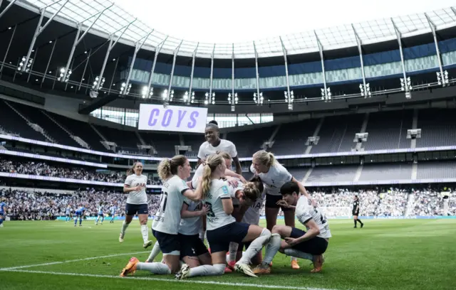 Spurs players celebrate their winning goal at the club's main stadium