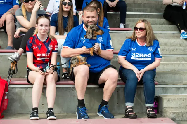 Rangers fans holding their sausage dog