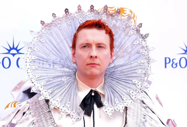 Comedian Joe Lycett has arrived wearing an elaborate dress that he says is a costume of...Queen Elizabeth I