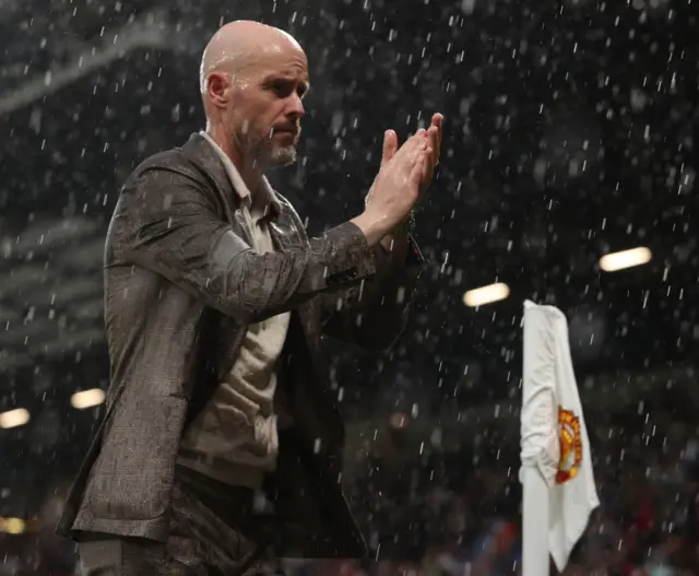 Erik ten Hag claps his hands as he leaves the field at Old Trafford