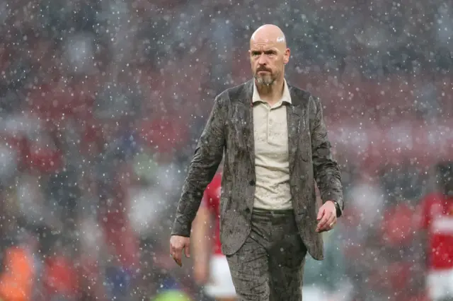 Erik ten Hag walks in the rain