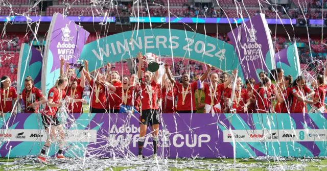 Manchester United Women's teams lifting the trophy after winning the FA Cup