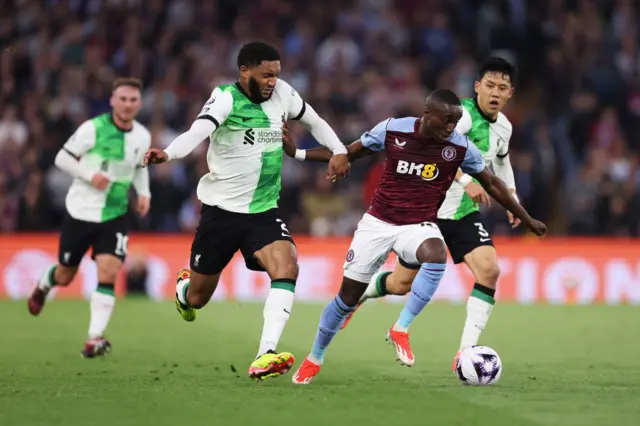 Moussa Diaby runs with the ball whilst under pressure from Joe Gomez