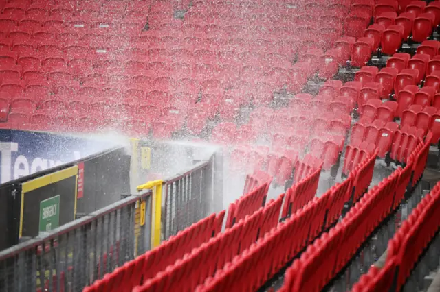 Rain falling from the roof on to seats inside Old Trafford