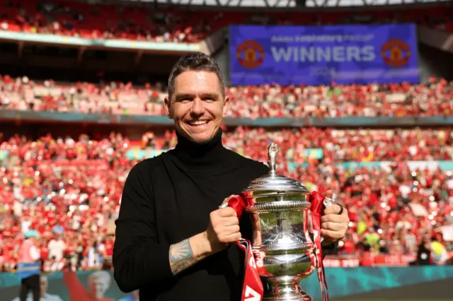 Marc Skinner holds the FA Cup trophy