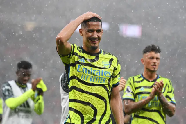 William Saliba smiles and places a hand on his head