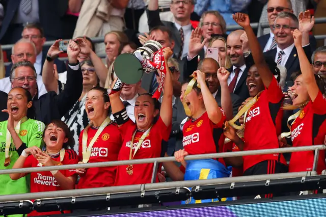 Katie Zelem lifts the FA Cup with her Manchester United team-mates