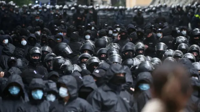 Law enforcement officers stand guard near the parliament building as demonstrators hold a rally to protest against a bill on "foreign agents" in Tbilisi, Georgia, May 14, 2024