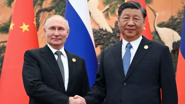 Russian President Vladimir Putin and Chinese President Xi Jinping shake hands in Beijing in October 023