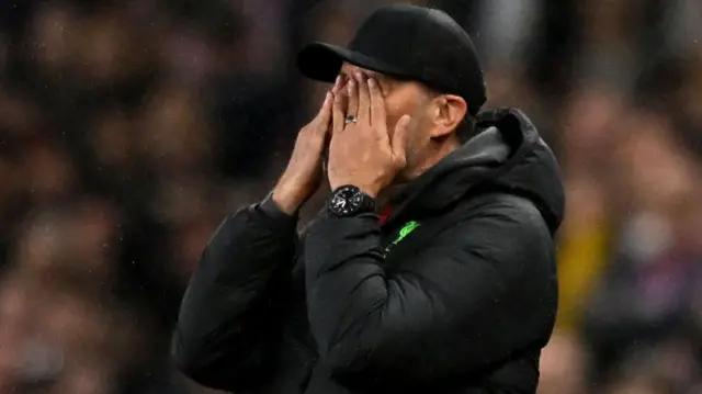 Jurgen Klopp with his head in his hands on the sidelines