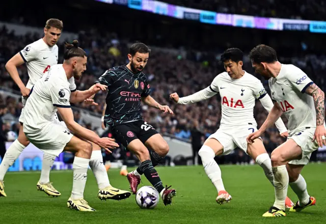 Bernardo Silva surrounded by Spurs players