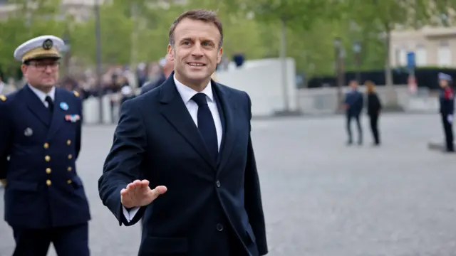 Emmanuel Macron walking on a street