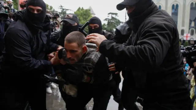 Georgian policemen detain protestors during a rally against a draft bill on 'foreign agents' in front of the Parliament building in Tbilisi, Georgia, 14 May 2024