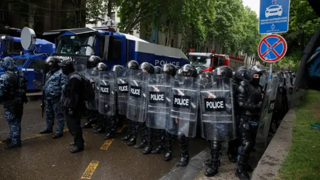 Georgian riot police block a street during a rally against a draft bill on 'foreign agents' near the Parliament building in Tbilisi, Georgia, 14 May 2024.