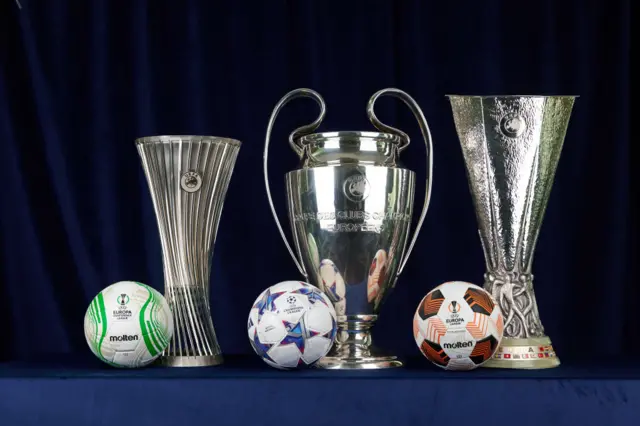 A group photo of the UEFA Europa Conference League trophies and ball, UEFA Champions League trophies and ball, and UEFA Europa League trophies and ball