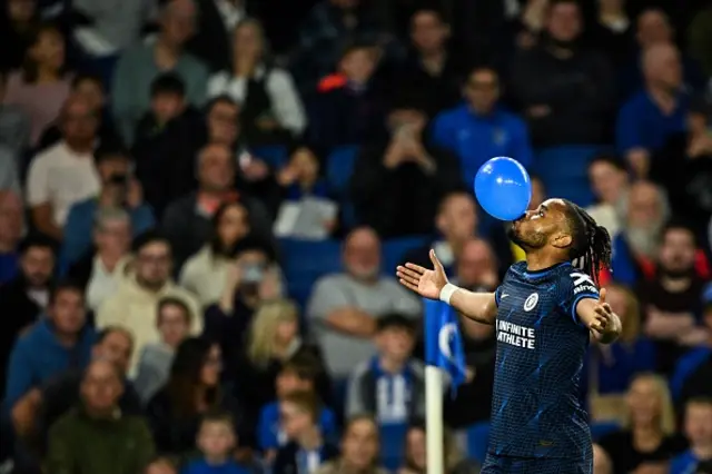 Christopher Nkunku celebrates blowing up a balloon