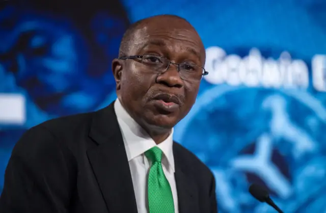 A man in a suit wearing a green tie