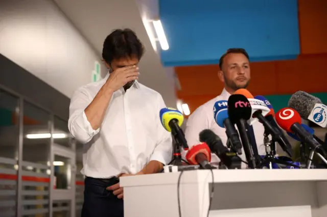 Slovak Defence Minister Robert Kalinak, flanked by Interior Minister Matus Sutaj Estok, reacts during a press conference at F.D. Roosevelt University Hospital, where Slovak Prime Minister Robert Fico was taken after he was wounded in a shooting incident in Handlova, in Banska Bystrica, Slovakia