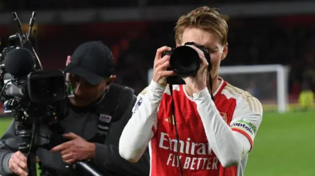 Martin Odegaard took a camera from the Arsenal club photographer as part of his celebrations after the  win over Liverpool in February