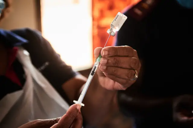 A health worker prepares a dose of the Johnson & Johnson Covid-19 vaccine during a rural vaccination drive by BroadReach Group, the public health implementation partner of the Mpumalanga Department of Health, at Duduzile Secondary School in Mpumalanga, South Africa, on Wednesday, March 9, 2022.