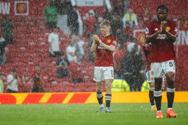 Rasmus Hojlund and Willy Kambwala of Manchester United applaud the fans