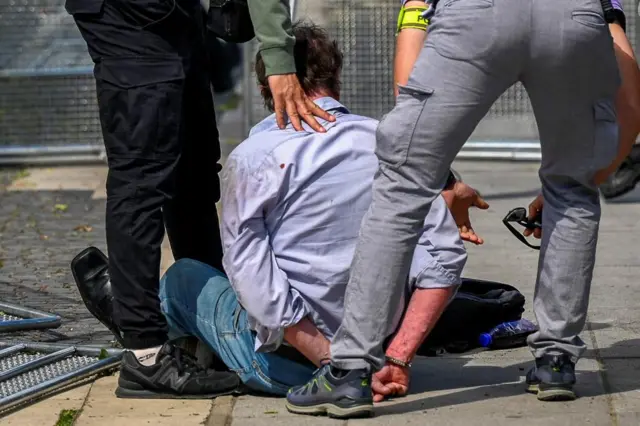 A person is detained after a shooting incident of Slovak PM Robert Fico, after a Slovak government meeting in Handlova, Slovakia, May 15, 2024.