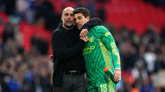 Pep Guardiola embraces Stefan Ortega