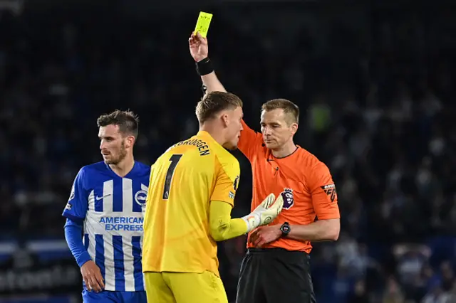 Bart Verbruggen speaks to the referee whilst receiving a yellow card