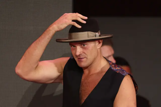 Tyson Fury holds his hat