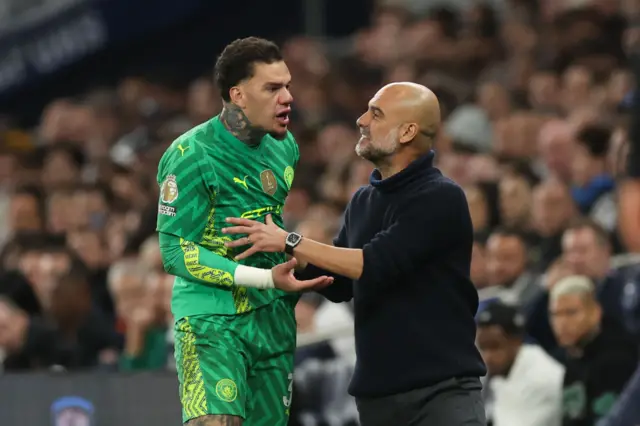 ep Guardiola the head coach / manager of Manchester City speaks to Ederson of Manchester City