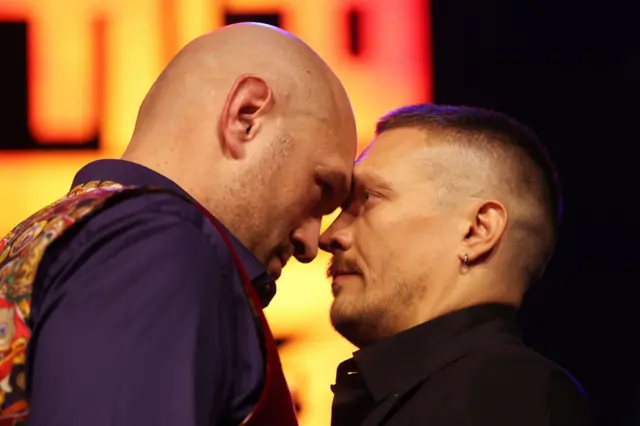 Tyson Fury and Oleksandr Usyk push their heads into each other