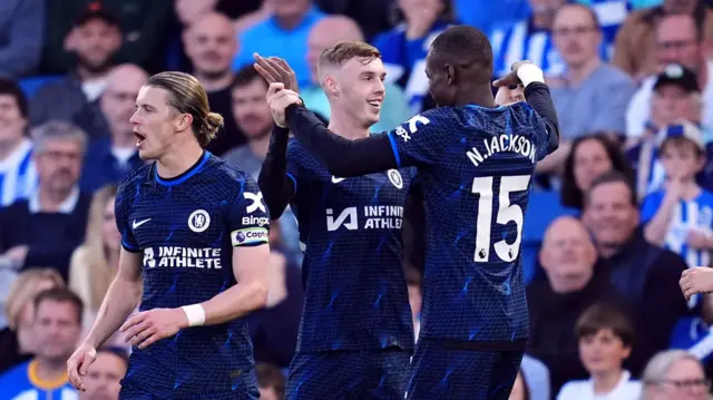 Chelsea players celebrate with Cole Palmer after his goal against Brighton