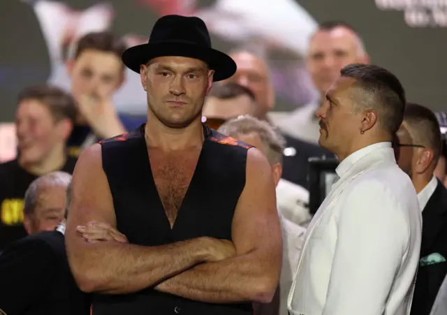 Tyson Fury stares ahead as Oleksandr Usyk during a face-off