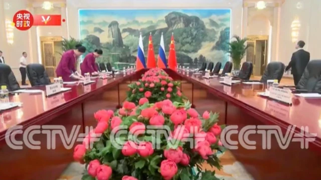 The meeting room being set up by attendants as shown on Chinese TV