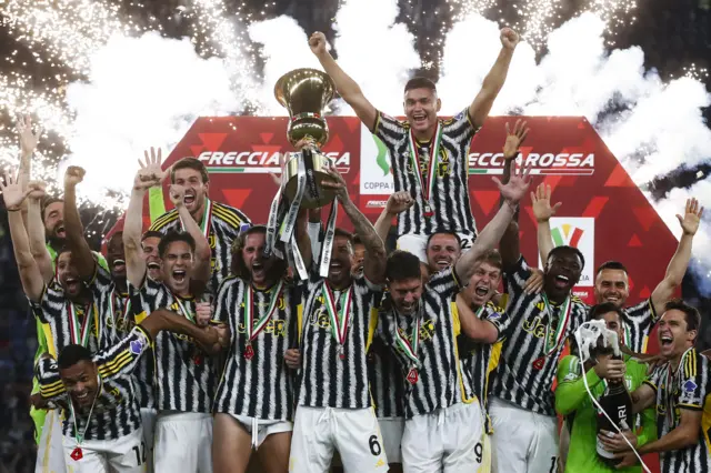 Juventus players celebrate as they are awarded with the Coppa Italia trophy in 2024