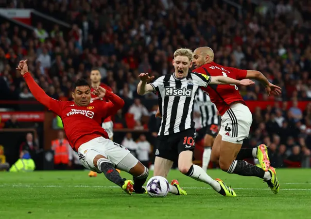 Anthony Gordon goes down in the Manchester United box after a challenge by Sofyan Amrabat