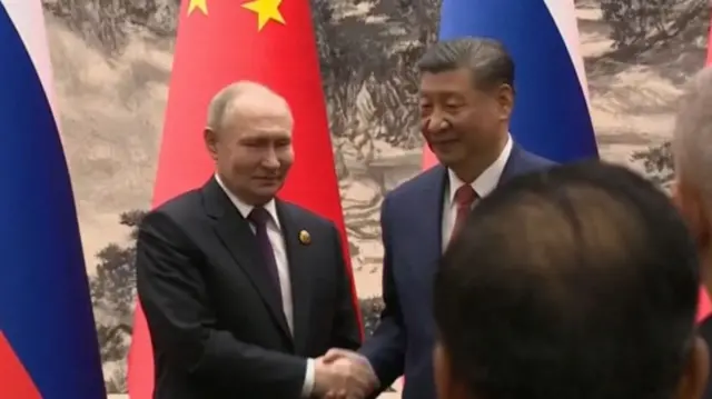 Putin and Xi shake hands at the end of the press conference