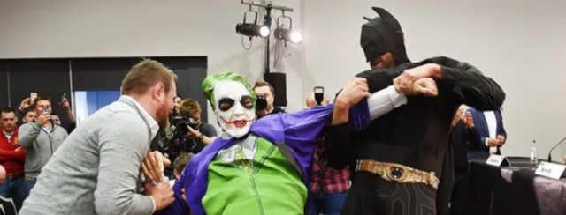 Tyson Fury (right) is dressed as Batman and wrestling with someone dressed as the Joker