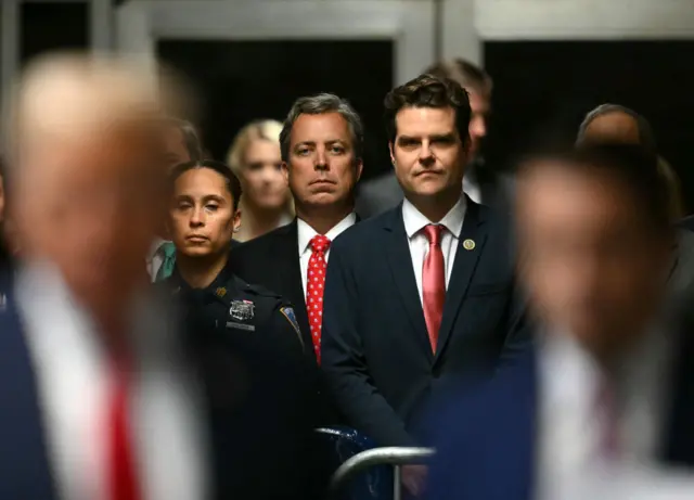 Rep. Matt Gaetz stands behind Donald Trump as the former president spoke to media before court started.